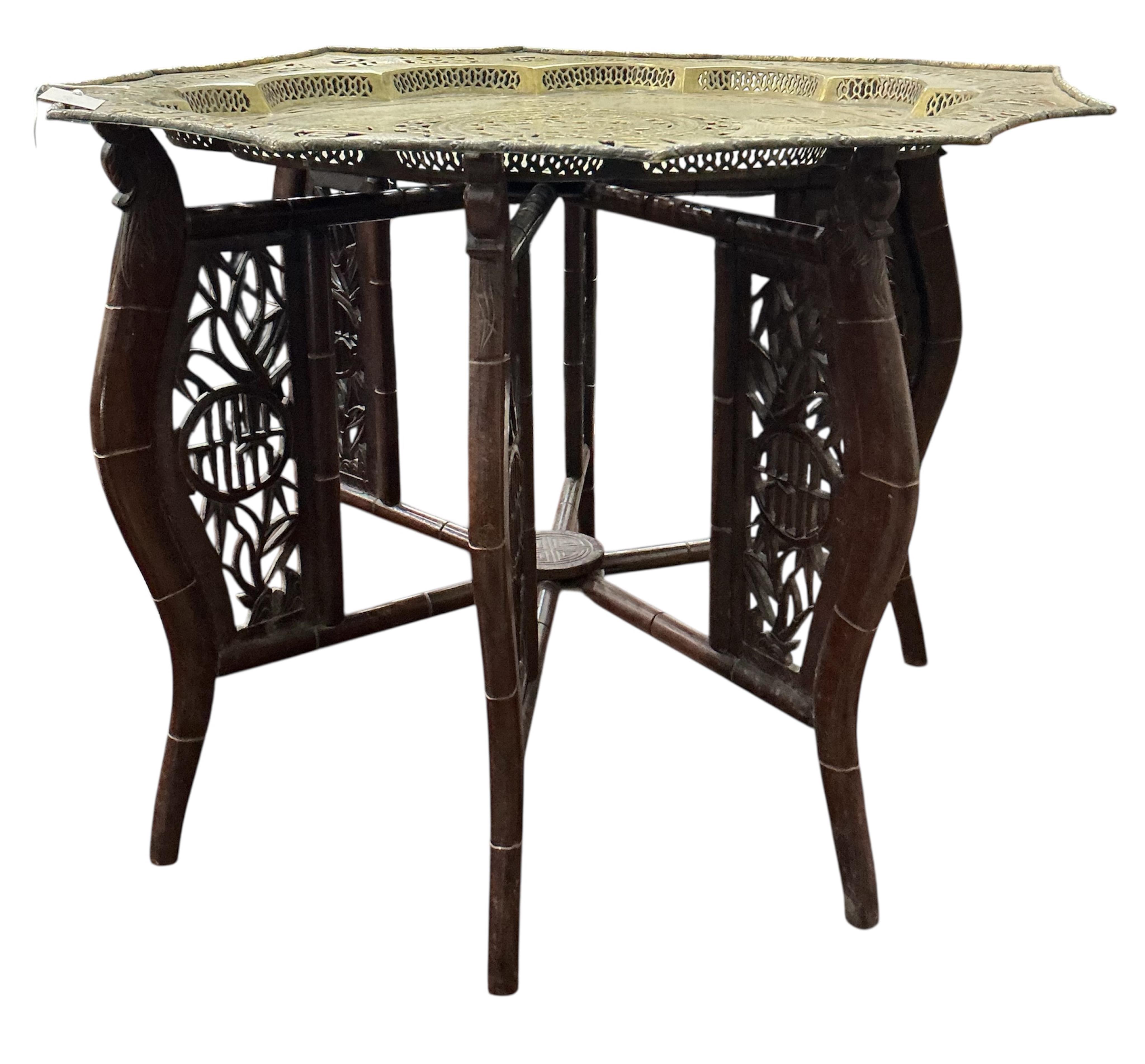 A Chinese pierced brass tray top table on hardwood folding stand, width 76cm, height 56cm